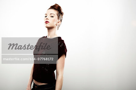 Studio portrait of aloof young woman