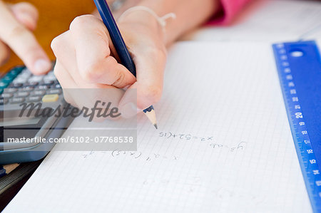 Teenage girls doing maths, close-up