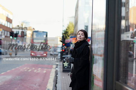 Young woman standing on bus stop Young woman standing on bus stop