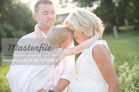 Parents with daughter on meadow, Sweden