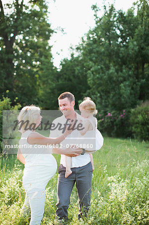 Parents with daughter on meadow, Sweden