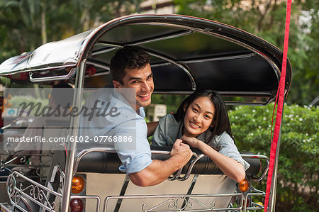 Smiling friends in rickshaw, Thailand