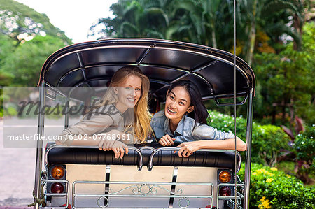 Young women on rickshaw, Bangkok, Thailand