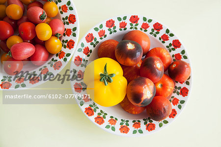 Tomatoes on plates, studio shot
