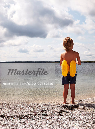 Boy at sea with life belt