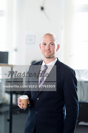 Smiling businessman with cup of coffee