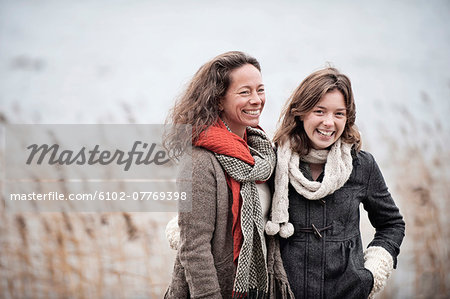 Mother and teenage daughter at water