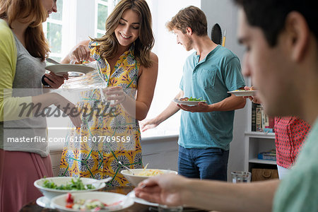 A family gathering for a meal. Adults and children around a table.