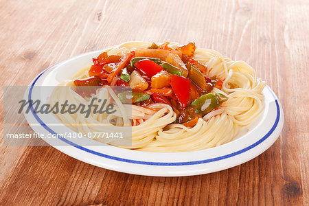 Delicious thai vegetarian pasta on white plate on wooden background. Healthy vegetarian eating.