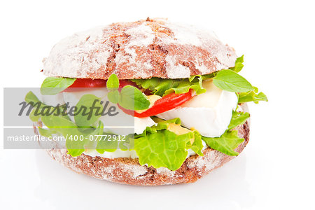 Wholewheat bread with fresh goat cheese, salad and fresh vegetables isolated on white.