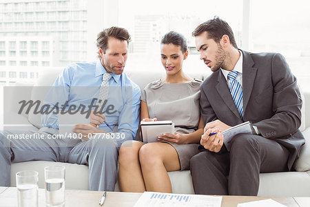 Young business people with notes in meeting at office