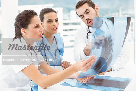 Male and female doctors examining x-ray in the medical office