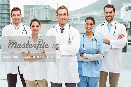 Portrait of confident doctors with arms crossed at medical office