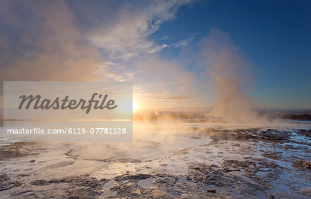 Steam rising from geothermal pools at sunrise in winter, Geysir, Haukardalur Valley, Iceland, Polar Regions
