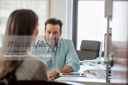 A woman and a man talking to each other.