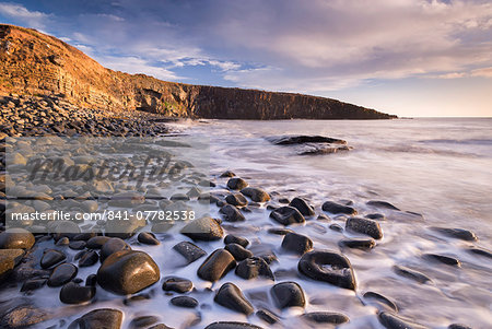 Waves lap against the seashore at Cullernose Point near Howick, Northumberland, England, United Kingdom, Europe