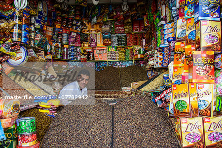 Man sitting in his full shop in the Old Town, UNESCO World Heritage Site, Sanaa, Yemen, Middle East