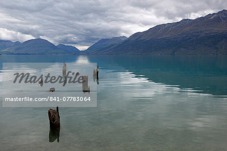 Old pier posts on Lake Wakatipu, Glenorchy, Otago, South Island, New Zealand, Pacific