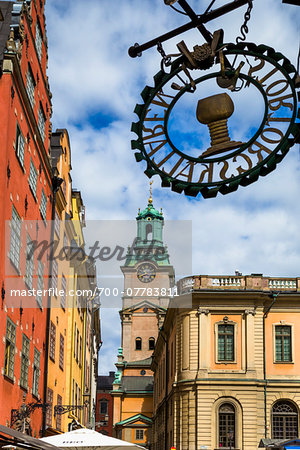 Colorful buildings and sign, Stortorget with Stockholm Cathedral (Church of St Nicholas, Storkyrkan (The Great Church) in the background, Gamla Stan (Old Town), Stockholm, Sweden