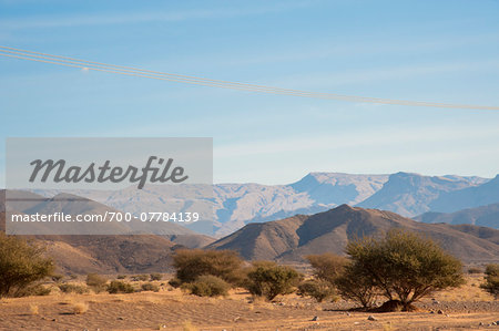 Mountains and Desert with Dry Bushes and Power Lines in the foreground, Al Kamil, Oman