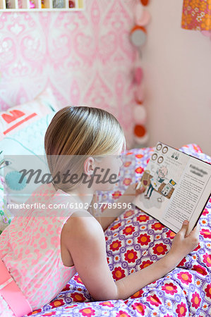 Girl reading in her room