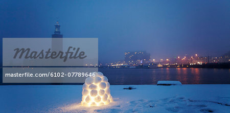 Snowball lantern with silhouette of Stockholm City Hall on background