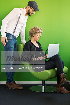 Colleagues using laptop together