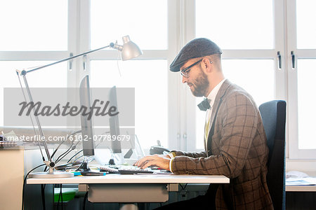 Mid adult man working in office Mid adult man working in office