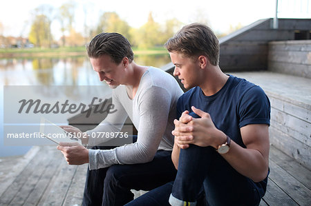 Young men using digital tablet