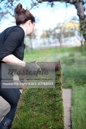 Woman putting new lawn