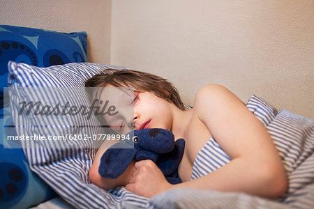 Boy sleeping with toy