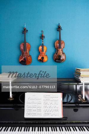 Violins hanging over piano