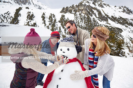 Family building a snowman together