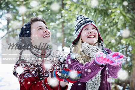 Siblings catching snow together