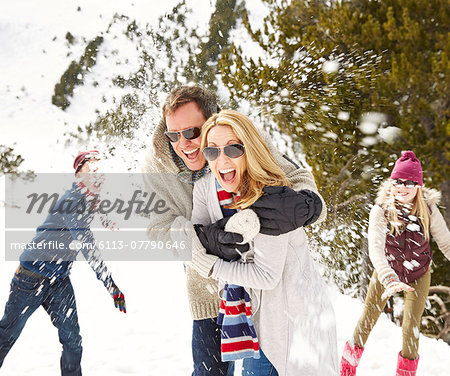 Family having a snowball fight in the snow