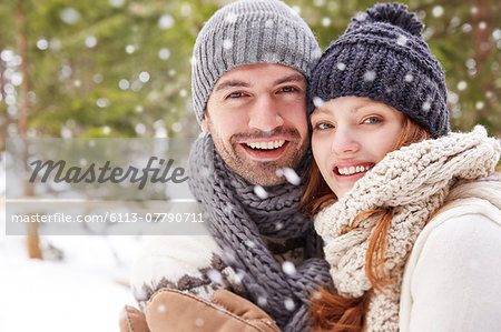 Couple hugging in snow