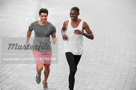 Men running through city streets together