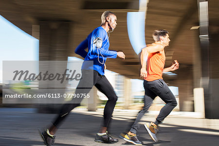 Men running through city streets together