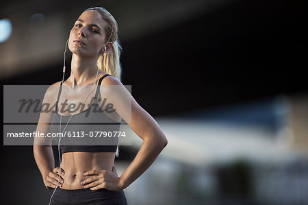 Woman resting after exercising on city street