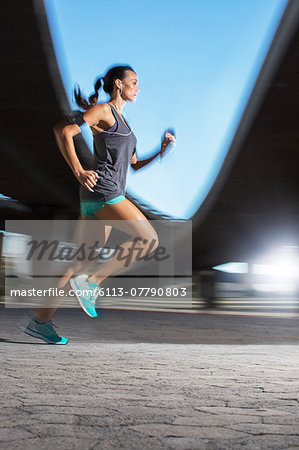 Woman running through city streets