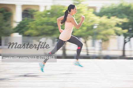 Woman running through city streets