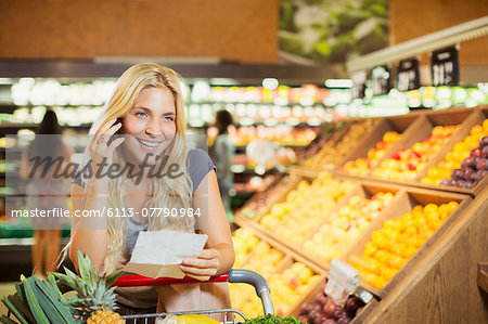 Woman talking on cell phone in grocery store Woman talking on cell phone in grocery store