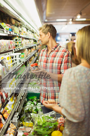 Couple shopping together in grocery store Couple shopping together in grocery store