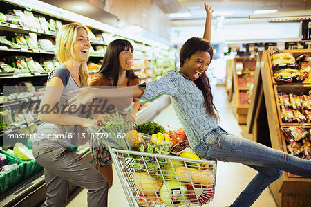Women playing together in grocery store