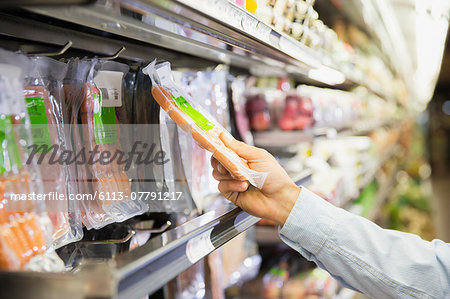 Man selecting product in grocery store