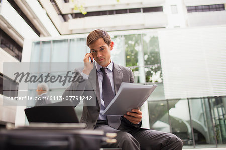 Businessman working on bench in office building