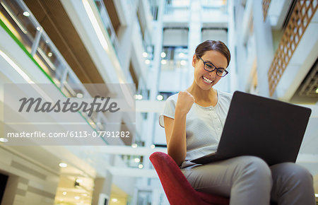 Businesswoman getting excited in office building