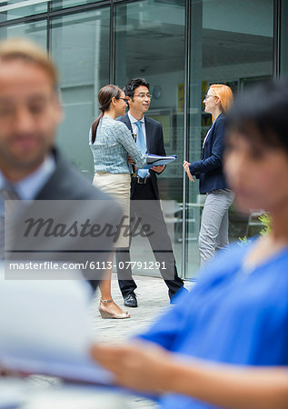 Business people talking outside of office building