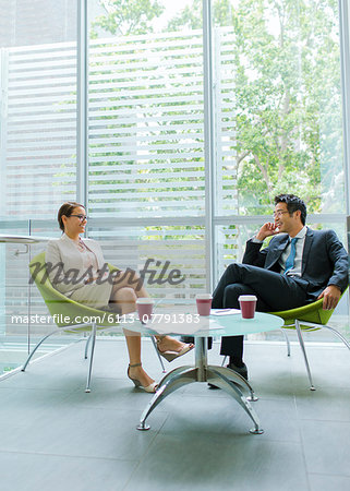 Business people talking at coffee table in office building