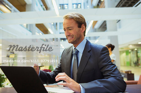 Businessman worried while using laptop